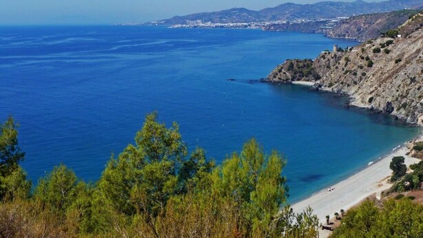 A coastal landscape with a beach, rocky cliffs, and a clear view of the sea. - La Perla - South Facing, Sun Morning to Evening (Nerja)
