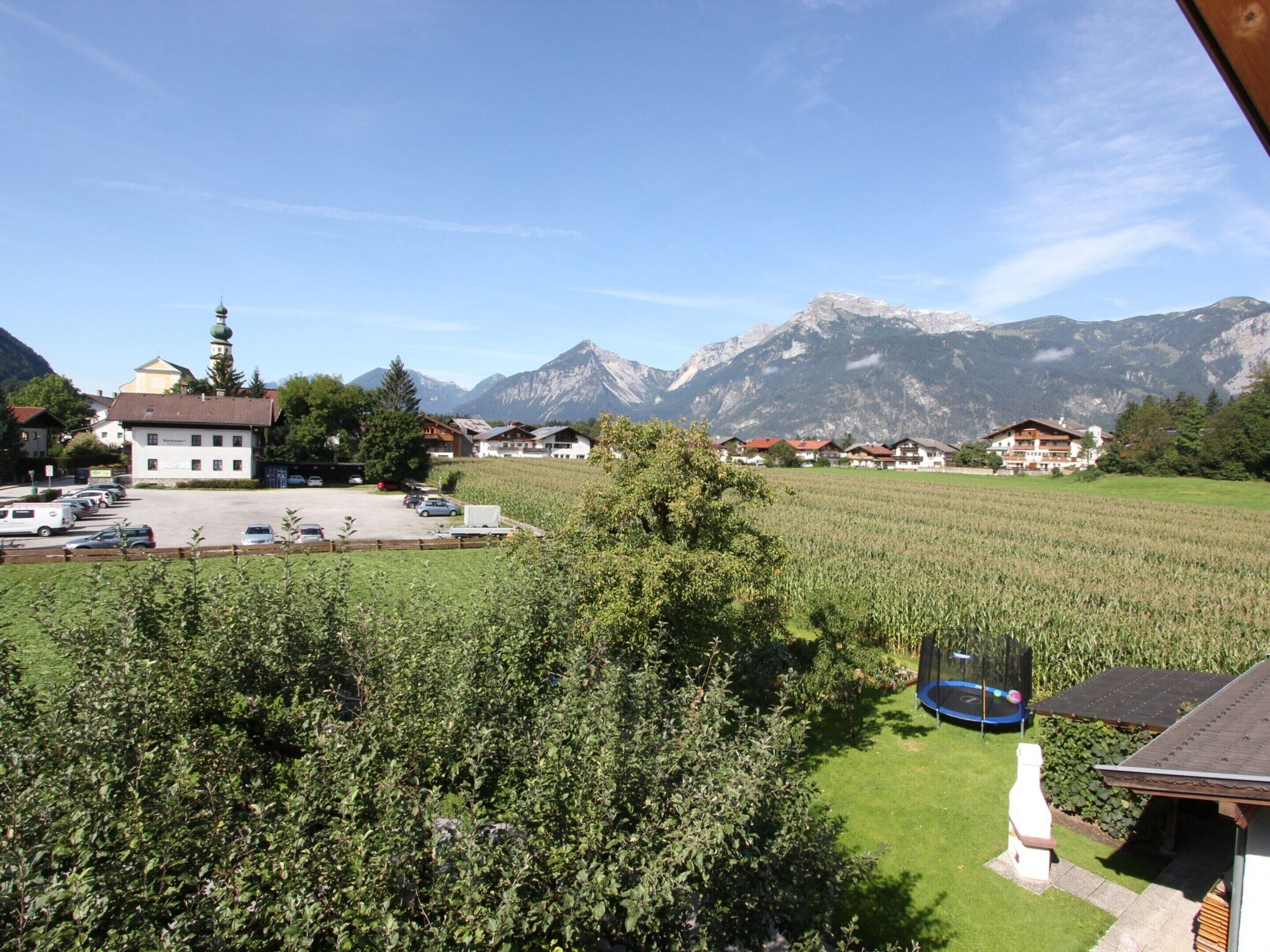 A rural setting with a church, a parking lot, and a field in the foreground.