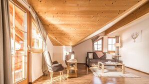 A spacious loft-style room with a high ceiling, wooden beams, and large windows. - Chalet in Reith Near Ski Juwel Alpbachtal (Reith im Alpbachtal)