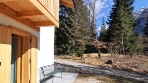 A wooden building with a bench outside. - Belvilla by OYO Pleasant Holiday Home With Garden (Lozzo di Cadore)