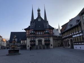 A historic building with a prominent tower and a courtyard. - Holiday Apartment on the Anger (Wernigerode)