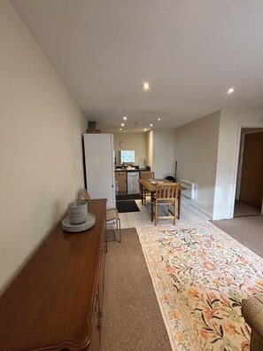 A compact living space with a dining area, a kitchenette, and a small entryway. - 2 Bedroom Flat in Spondon Derby (Spondon)