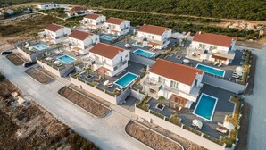 A modern resort with multiple white buildings, each with a swimming pool and outdoor seating areas. - Comfort Villa With Swimming Pool and Terrace (Sukosan)