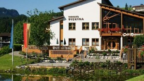 A building with a sign reading "KUMHAUS PISKINA" and a "Cafe-Restaurant" sign on the right. - 1 Porzig Modern Retreat (Fischen im Allgaeu)