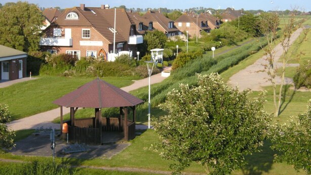 A residential area with houses, a gazebo, and a pathway. - Blauort in Friedrichskoog-spitze (Friedrichskoog)