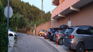 A parking area with multiple cars parked in front of a building with a sign that reads "STAFF ONLY". - Apartments St Rialto - Comfort One-bedroom Apartment With Balcony and Sea View (Jelsa)