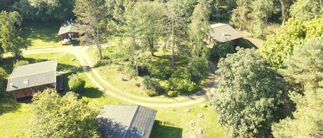 A rural property with multiple cabins surrounded by dense forest.