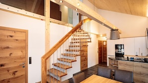 A modern kitchen with wooden cabinetry and a built-in oven. - Spacious Apartment With Sauna (Haus)