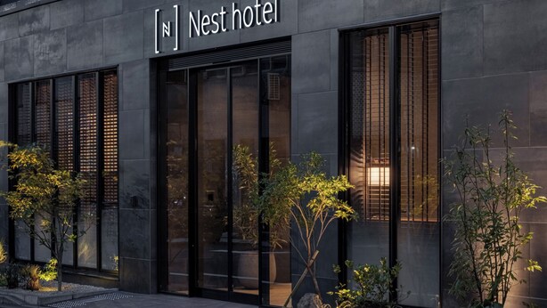 A modern hotel facade with a sign reading "Nest hotel" and large windows. - Nest Hotel Tokyo Yaesu (Tokyo)