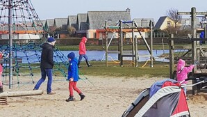 A playground with climbing structures and a sandy area. - Arielle by the Sea Comfortable Holiday Residence (Julianadorp)