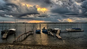 A marina with docked boats and wooden walkways leading into the water. - Holiday Home in Rosolina Mare Near Beach (Rosolina)