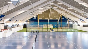 An indoor sports facility with multiple courts, including a basketball court and a tennis court, with a high ceiling and modern lighting. - 7 Person Holiday Park Home in Ebeltoft (Ebeltoft)