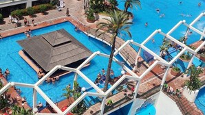 A large outdoor swimming pool with multiple lanes, surrounded by palm trees and lounge areas. - Apartment With Beach View (Benalmádena)