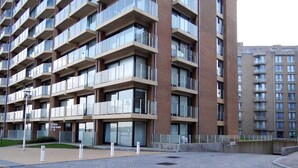 A modern multi-story building with a brick facade and large windows. - Attic Apartment Nieuwpoort by the Sea Wall (Nieuwpoort)