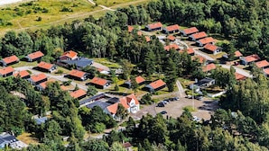 An aerial view of a residential area with houses, a parking lot, and a beach. - 6 Person Holiday Park Home in Vaeggerlose (Vaeggerlose)