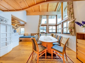 A dining area with a wooden table, chairs, and a bench. - Chalet in Mittersill Near Ski Slopes (Mittersill)