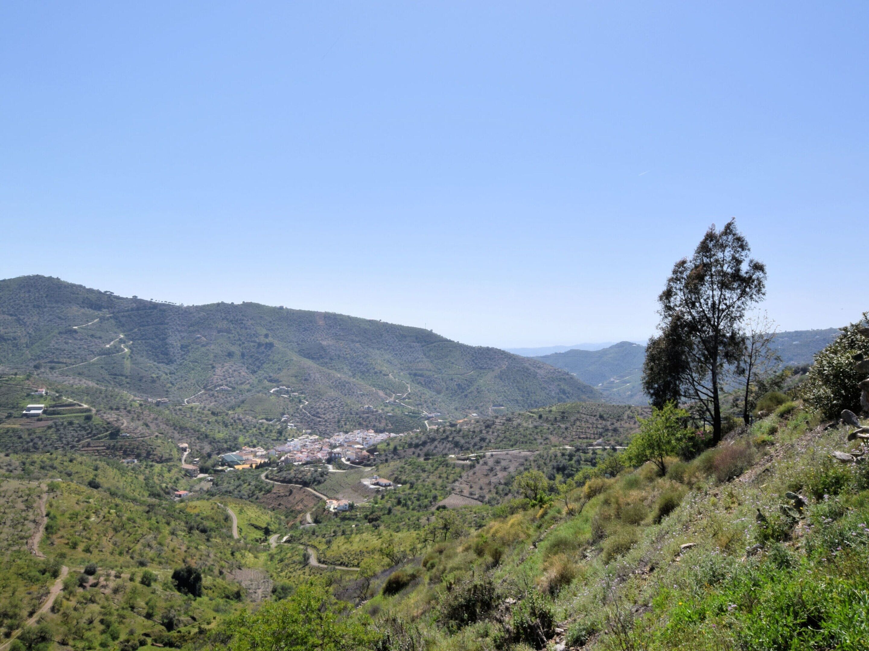 A mountainous landscape with a small town nestled in the valley.