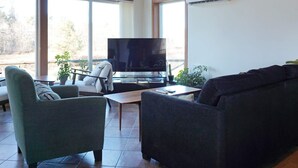 A living room with a television, two sofas, and a coffee table. - 5 Star Holiday Home in Lysekil (Lysekil)