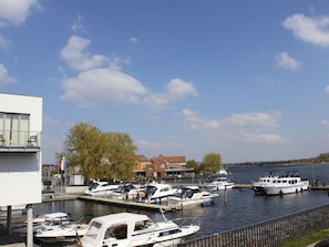 Guests can enjoy stunning views of the marina from the balcony of this waterfront retreat.