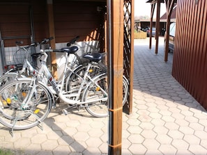 Bicycles are parked in a secure area adjacent to the building.