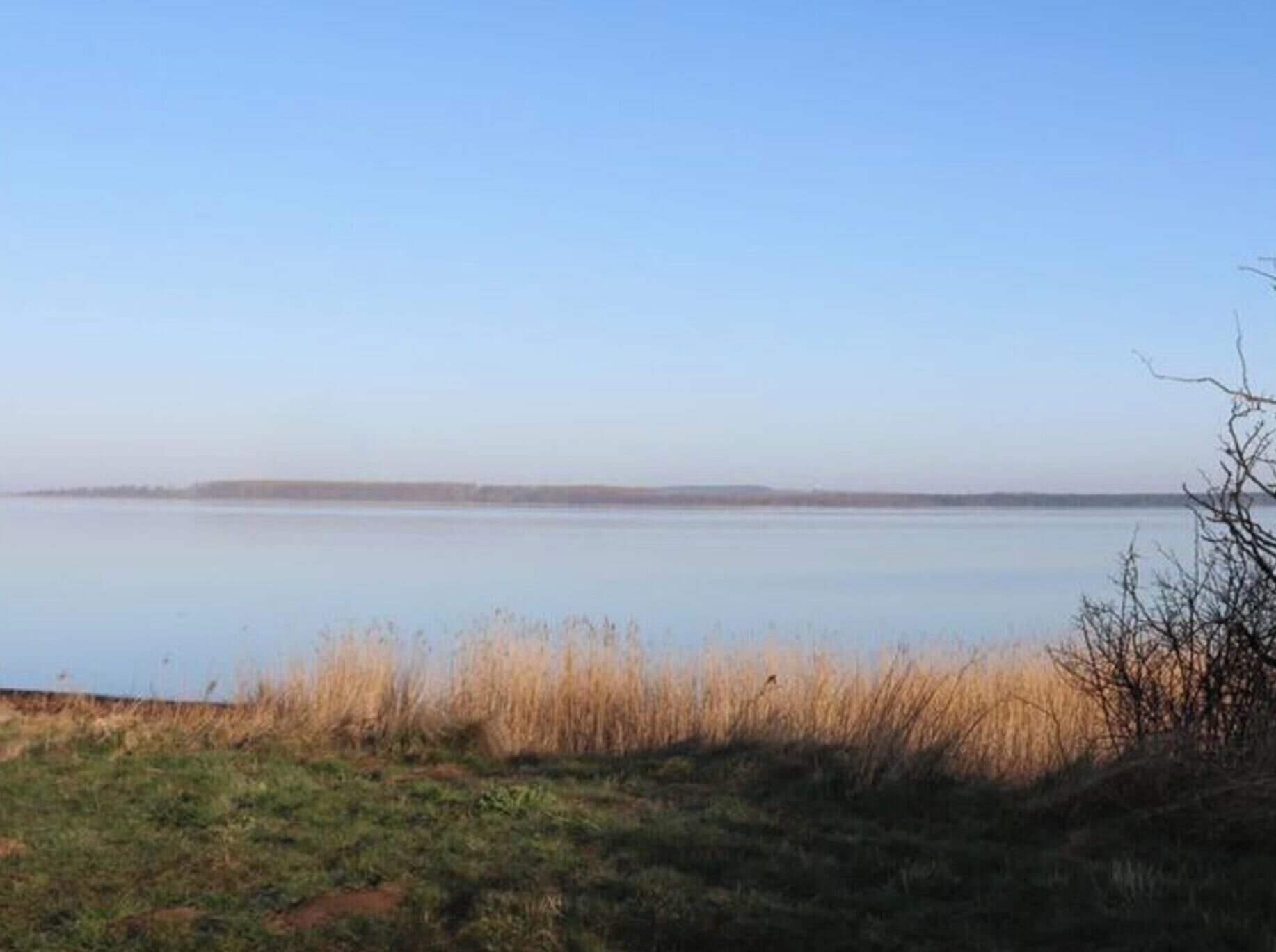 A calm lake with a clear sky.