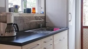 A kitchen with a coffee maker, a sink, and cabinets. - 8 Person Holiday Home in Hogklint-by Traum (Visby)
