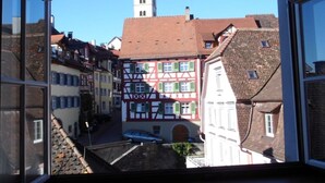 A traditional European town with half-timbered buildings and a church tower. - Lake Constance Hearts (Meersburg)