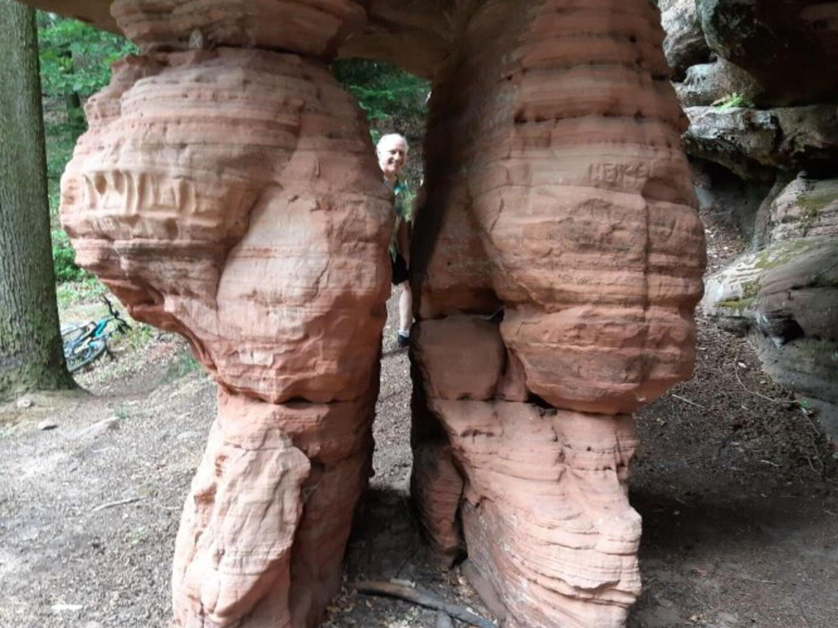 A large rock formation with visible stratification and erosion patterns.