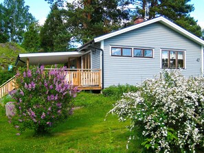 A single-story house with a porch, a small deck, and a number '42' on the side. - 4 Star Holiday Home in Malmkoping (Malmkoping)