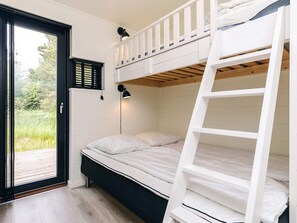 A bunk bed room with a ladder, a desk, and a window with blinds. - 7 Person Holiday Home in Albaek (Aalbaek)