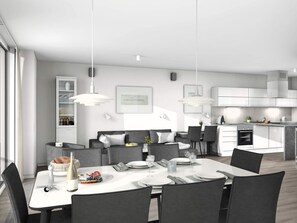 Een moderne keuken met witte kasten, een eethoek met een witte tafel gedekt voor vier personen, en een inbouwoven.