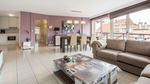 A modern apartment with a dining area, kitchen, and a balcony with a view of the city. - La Boheme 204 G1 Stylish Apartment in Koksijde (Koksijde)