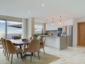 A modern kitchen with a central island, stainless steel appliances, and pendant lighting. - Dia Dourado Comfortable Holiday Residence (Ponta do Sol)