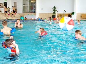An indoor swimming pool with multiple lanes, a lifeguard chair, and a large inflatable beach ball. - 8 Person Holiday Park Home in Grasten (Grasten)