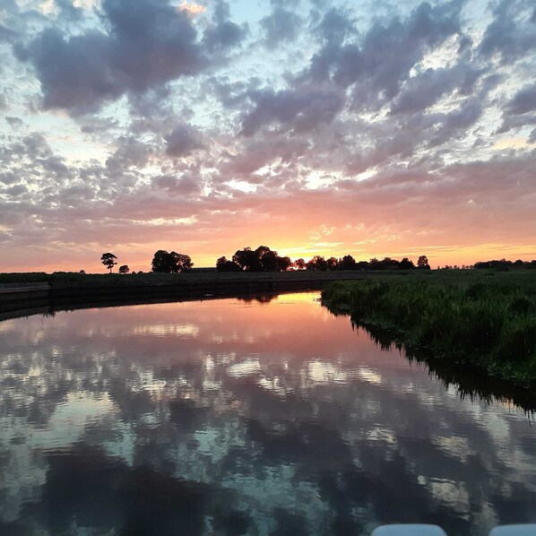 A calm water body reflecting the sky.
