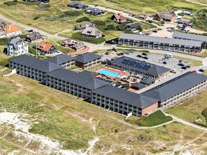 An aerial view of a hotel complex with multiple buildings, a swimming pool, and a parking area. - 6 Person Holiday Park Home in Fano (Fano)