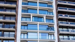 A multi-story building with a modern architectural design, featuring a mix of glass and concrete facades, and multiple balconies. - Beautiful Apartment With Phenomenal sea View (Middelkerke)