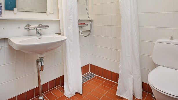 A bathroom with a white sink, toilet, and shower area. - 6 Person Holiday Park Home in Gilleleje (Gilleleje)