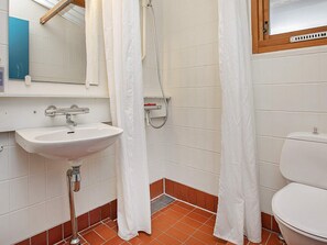 A bathroom with a white sink, toilet, and shower area. - 6 Person Holiday Park Home in Gilleleje (Gilleleje)