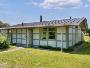 A small, single-story building with a sloped roof, a door, and windows. - 6 Person Holiday Park Home in Gilleleje (Gilleleje)
