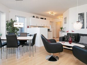 A modern living space with a dining area, kitchen, and seating area. - 5 Person Holiday Home on a Holiday Park in Bogense (Bogense)