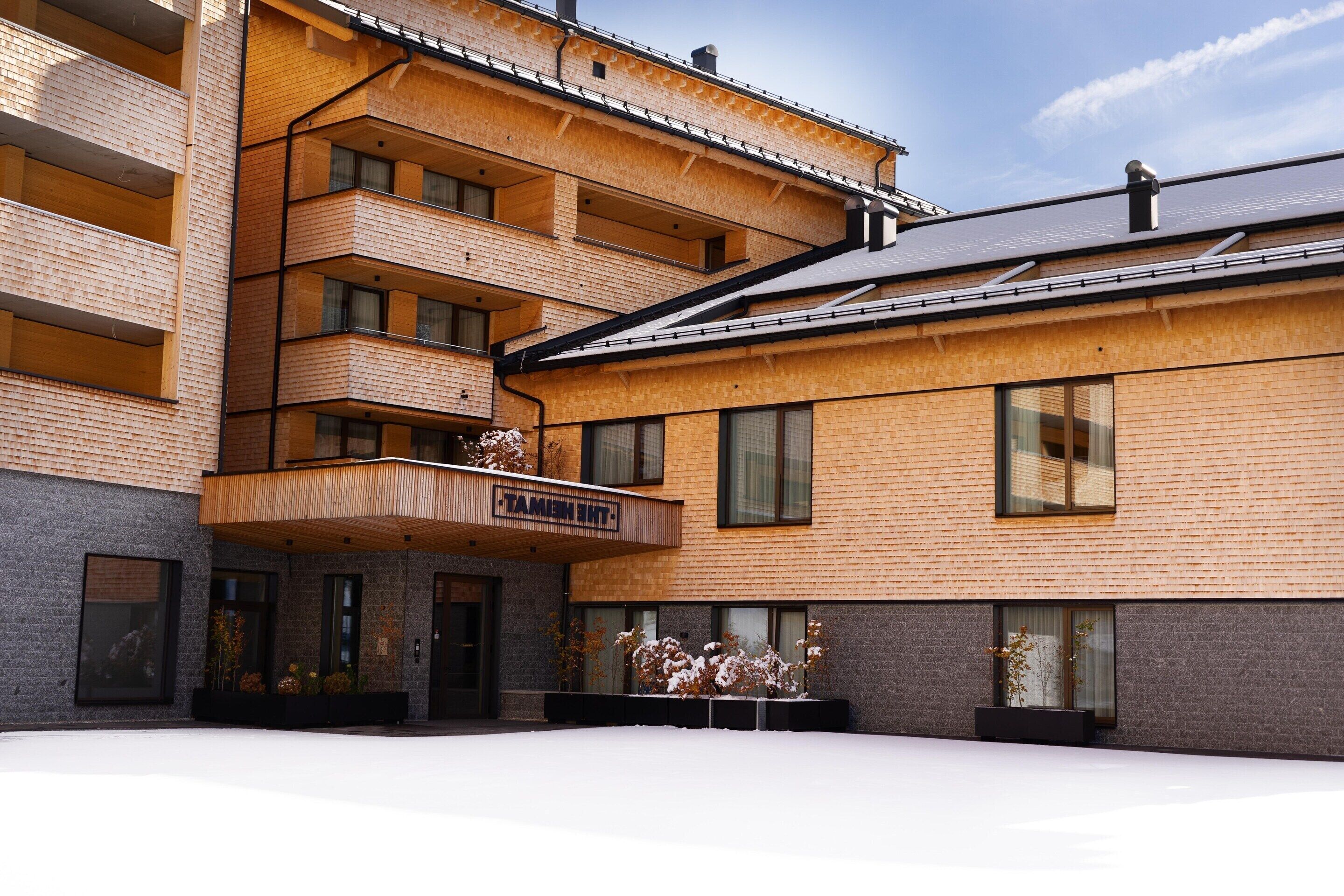 A multi-story building with a brick facade and wooden balconies.