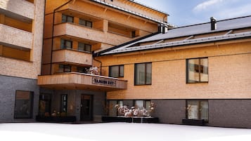 A multi-story building with a brick facade and wooden balconies.