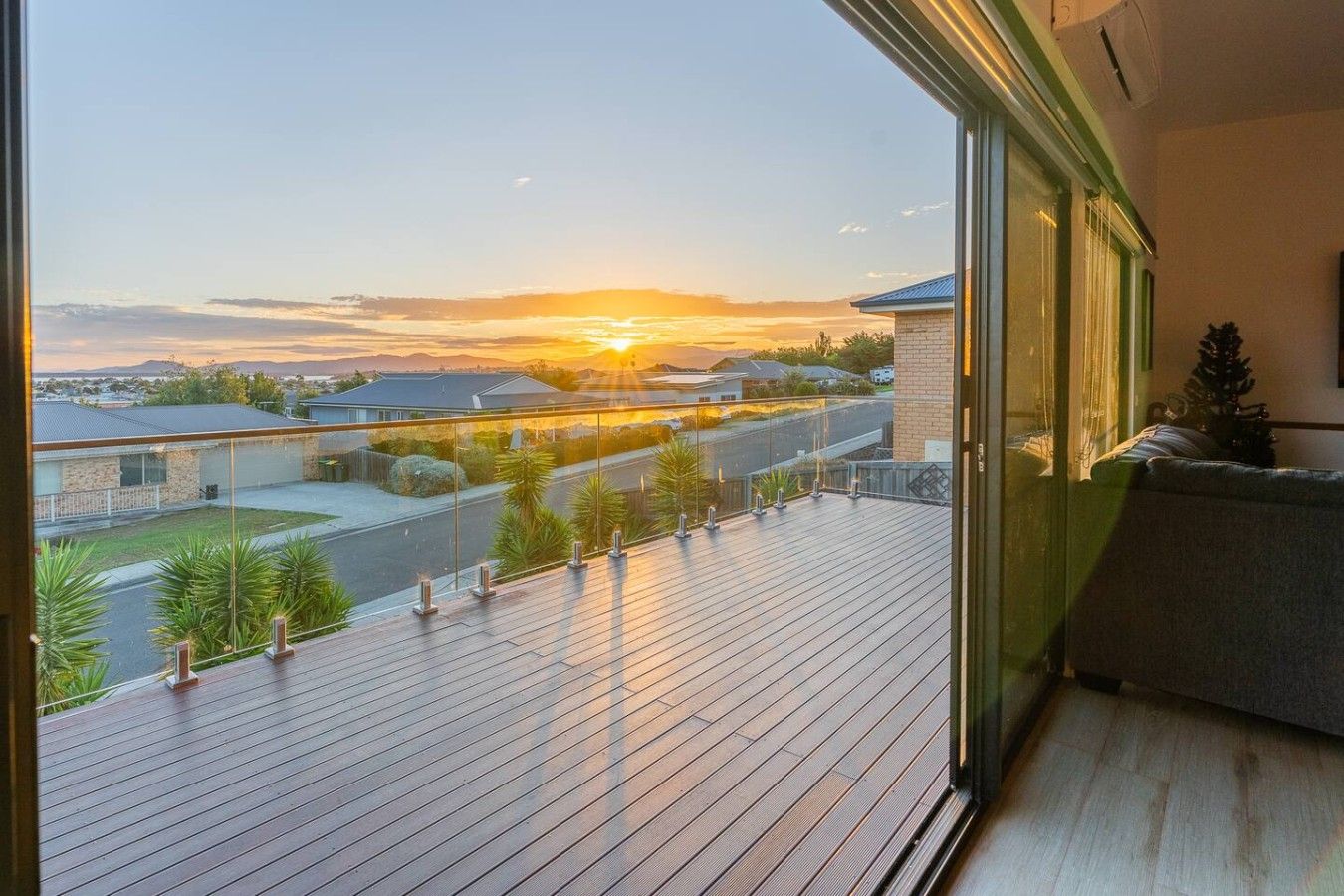 Un balcon donnant sur un quartier résidentiel au coucher du soleil.