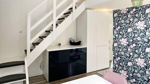 A modern interior with a staircase, a kitchen area, and a dining space. - 4 Star Holiday Home in Rockneby (Rockneby)