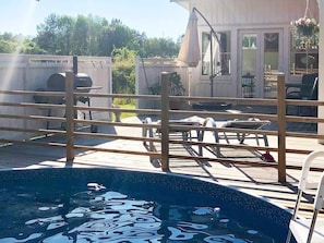 A pool area with a wooden deck, a lounge chair, and a hanging chair. - 4 Star Holiday Home in Rockneby (Rockneby)