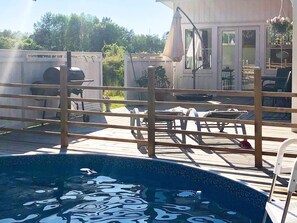 A pool area with a wooden deck, a lounge chair, and a hanging chair. - 4 Star Holiday Home in Rockneby (Rockneby)