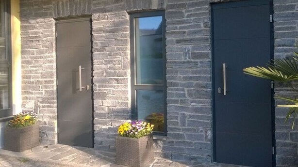 A building with stone facade, two doors, and windows. - Apartment in Eibenstock (Eibenstock)