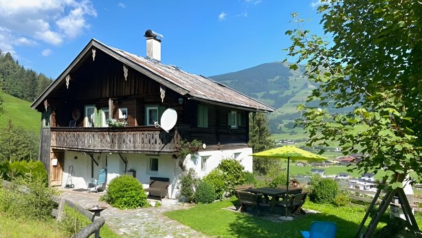 A rustic chalet with a balcony, a satellite dish, and a view of a green valley and mountains. - Farmhouse in Hollersbach Near Kitzski (Hollersbach im Pinzgau)