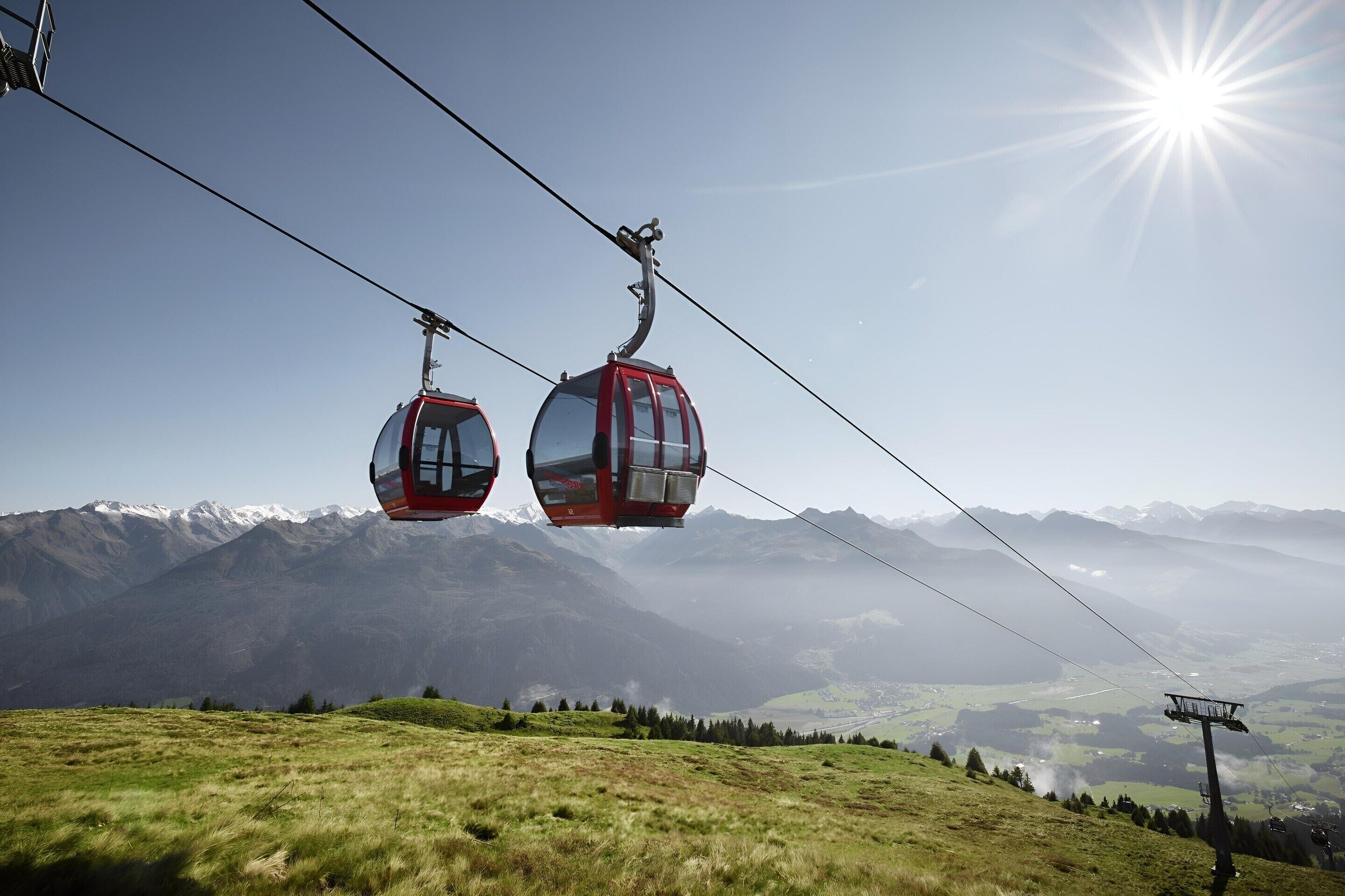 A cable car system with a mountainous landscape in the background.